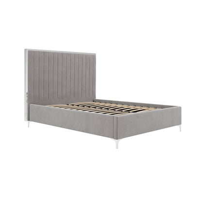 The Killarney Mink Upholstered 5ft King Size Bed features a tall ribbed headboard, side rails, footboard, and white metal legs with wooden slats, offering elegant modern style for any bedroom.