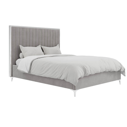 The Killarney Mink Upholstered 4ft6 Double Bed features a tall ribbed headboard in grey velvet, a matching frame, white bedding with two pillows, and slender silver legs, perfect for a stylish modern bedroom.